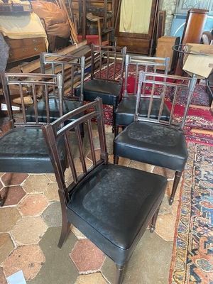 four chairs that are sitting on a rug in a room