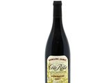 a bottle of wine sitting on top of a white table