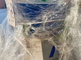 a large blue barrel wrapped in plastic on top of a table