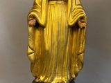 gold statue of the virgin of guadalupe on a blue base