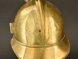 brass helmet on a stand on a black background