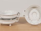 a white bowl and a white plate on a wooden table