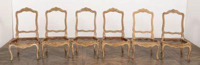 six chairs in a row in a room with a wall in the background