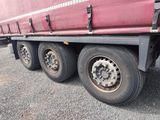 a red truck that is parked on the side of the road