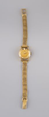 a close up of a wrist watch on a white surface