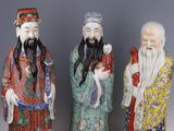 three chinese figurines of men with long hair and beards