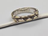 a close up of a wedding ring on top of a piece of paper