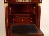 an antique wooden desk with a black leather top and gold accents