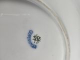 a white plate with a blue and white design on it