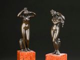 pair of bronze figurines of a woman and a man on marble bases