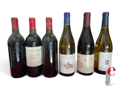 several bottles of wine are lined up on a white surface