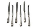 four silverwares with a knife and a fork on a white surface