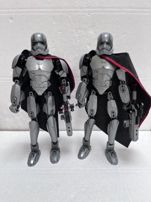 two star wars action figures standing next to each other