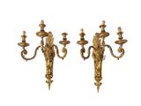 pair of antique brass wall sconces on a white background