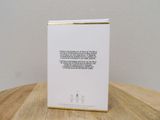 a white box on a wooden table with a quote on it
