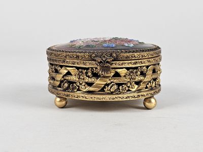 an image of a gold plated box with flowers on it
