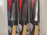 three knives are in the package on a white surface