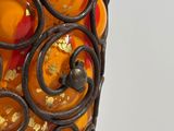 a vase that has a lot of oranges inside of it