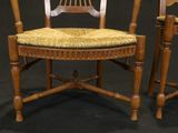 pair of antique wooden chairs with yellow upholstered cushions