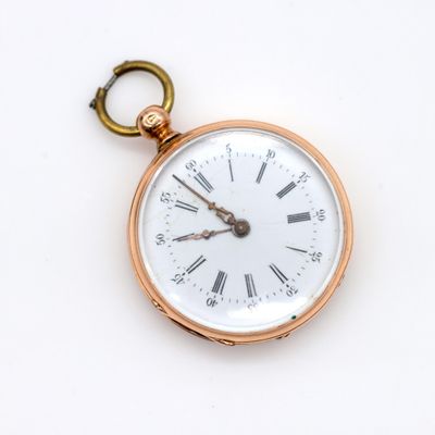 a gold pocket watch with roman numerals on it