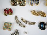 many different types of jewelry on a white surface
