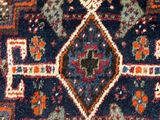 a close up of a rug with a diamond design on it