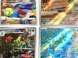 four different pokemon trading cards are displayed on a white surface