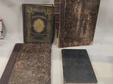 three old books sitting on a table next to each other on a white surface