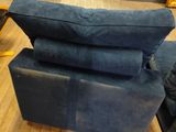 a blue couch sitting on top of a wooden floor