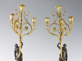 pair of antique brass candelabs with figurines on marble bases
