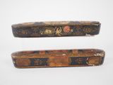 pair of antique wooden boxes with floral designs on them on a white background