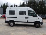 a white van parked in a parking lot with trees in the background