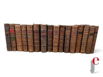 several old books are lined up in a row on a white surface