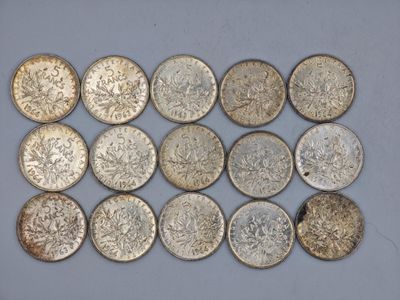 a bunch of silver coins sitting on top of a white surface