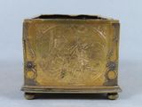 a gold colored box with a design on it