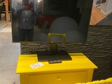 a yellow desk with a tv on it and a yellow chair