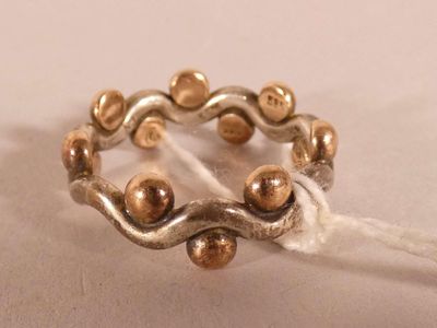 an image of a ring made of silver and gold beads
