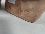 a close up of a vase with a tag on it