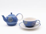 a tea pot and a cup sitting on a saucer