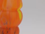 a close up of a glass vase with orange and yellow colors