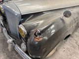 an old car that is sitting in a garage