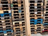 a stack of pallets in a warehouse filled with boxes