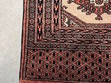 a rug on the floor with a cat sitting on it