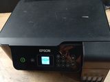 a black printer sitting on top of a wooden table