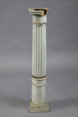 a white pillar with a wooden top on a gray background