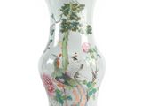 a white vase with a painting of birds and flowers on it