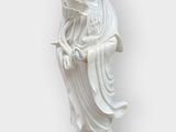 white statue of a woman holding a flower on a white background