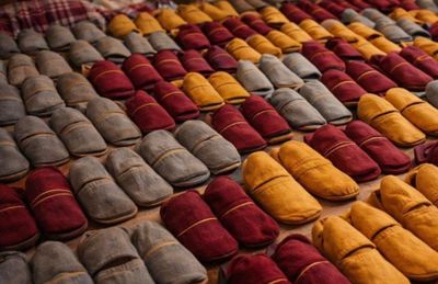 several pairs of slippers are lined up on a table