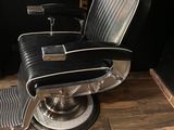a barber chair in the corner of a barber shop