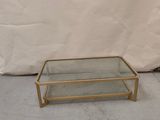 brass and glass coffee table with a glass top